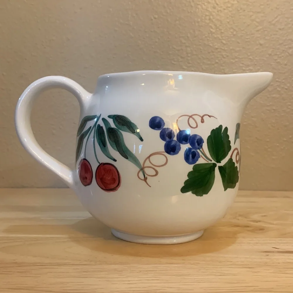 Crate & Barrel white ceramic pitcher hand painted with cherries and grapes.